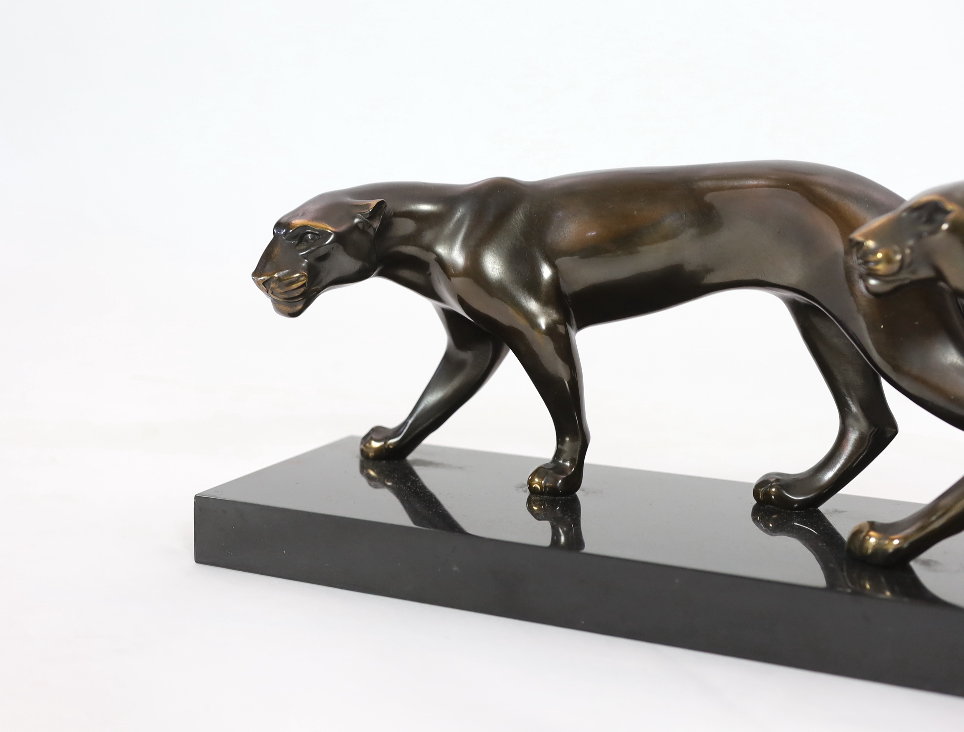 Marty Font, a French Art Deco bronzed and black marble group of two prowling panthers, 68cm wide, 18cm high